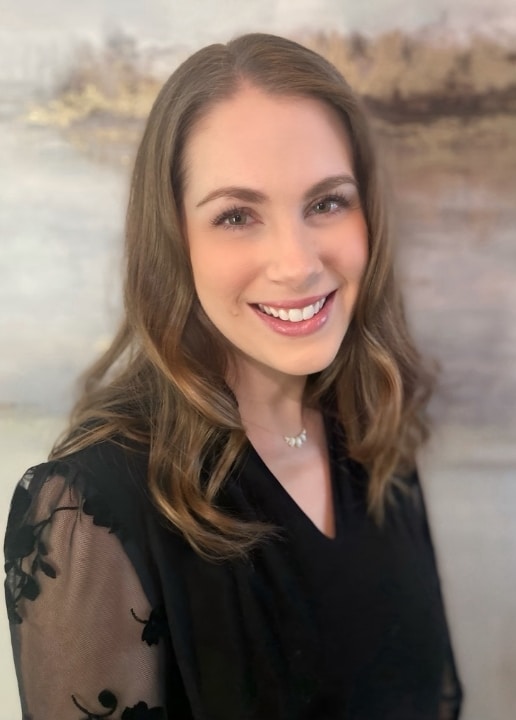 Portrait of Elyse Weed, MPAS, PA-C, smiling, in a black lace top