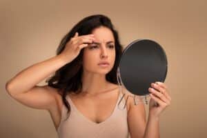 Young woman worried about wrinkles and considering preventative BOTOX